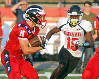 William D. Leiws The Vindicator  Niles's Robbie Savin (28) tries to elude Girard's Jamil Bannister (10) during the game at Niles on Aug. 23, 2018.