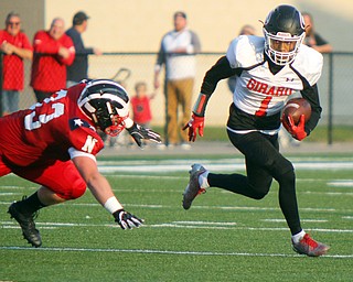 William D. Leiws The Vindicator  Girard's Jimmy Jones (1) eludes Niles' David May (33) during the game at Niles on Aug. 23, 2018.