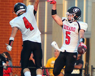 William D. Leiws The Vindicator  Girard's Nick Malito (5) high-fives Aidan Wargo (4) after scoring a touchdown in the second quarter of the game at Niles on Aug. 23, 2018.