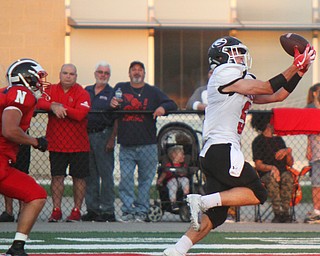 William D. Leiws The Vindicator  Girard's Nick Malito (5) catches a touchdown pass in the second quarter while being chased by Niles's Seth McMillion (5) during the game at Niles on Aug. 23, 2018.