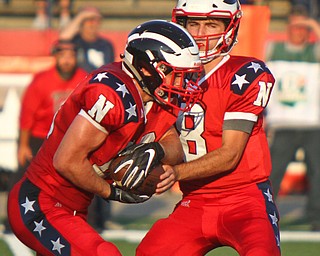 William D. Leiws The Vindicator  Niles quarterback Zack Leonard (8) hands off to Robbie Savin (28) during the game at Niles on Aug. 23, 2018.