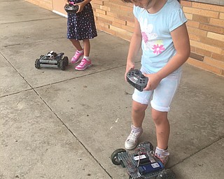 Neighbors | Submitted.Harper Davis and Gianna Costas navigate remote control robots from MCCTC Robotics Mobile lab that visited Boardman's Success by 6 program.