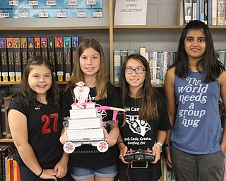 Neighbors | Abby Slanker.Team People, including, from left, seventh-grader Ava Arundel, sixth-grader Jenna Wilkeson, sixth-grader Lauren Smallwood and seventh-grader Simran Joshi, built a cakebot at the fifth annual Robotics Camp at Canfield High School on Aug. 10.