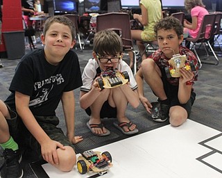 Neighbors | Abby Slanker.First year Robotics Camp attendees, from left, sixth-grader Cameron Bourque, sixth-grader Jack Graham and seventh-grader Braden Royea built their own robots and tested them on the track during the fifth annual Robotics Camp at Canfield High School on Aug. 10.