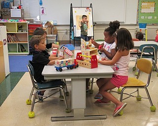 Neighbors | Jessica Harker.Children played with puzzles on the table during a center on Aug. 16 at the Poland Success by 6 program.