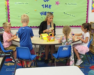 Neighbors | Jessica Harker.Success by 6 instructor Samantha Cox sat and worked with a group of children in a break out center on Aug. 16 at Poland Union Elementary.