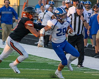 Poland receiver Mitchell Frederick is pushed out of bounds by Marlington defender Ryan Cooley in the Bulldogs' 17-14 victory Thursday night in Alliance...BOB ETTINGER | THE VINDICATOR.￼..