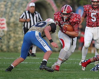 Steven Anderson (19) of Columbiana lowers his shoulder on Western Reserve's Ryan Slaven (30) during Thursday night's matchup at Firestone Park in Columbiana. Dustin Livesay  |  The Vindicator  8/23/18  Columbiana