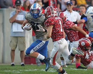 Adam Gatrell (31) of Western Reserve puts out an arm to prevent the tackle by Columbiana's Brandt Virden (1) during Thursday night's matchup at Firestone Park in Columbiana. Dustin Livesay  |  The Vindicator  8/23/18  Columbiana