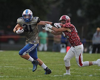 Adam Gatrell (31) of Western Reserve sheds a tackle attempt by Columbiana's Carter Pasco (22) during Thursday nights matchup at Firestone Park in Columbiana. Dustin Livesay  |  The Vindicator  8/23/18  Columbiana