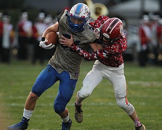 Adam Gatrell (31) of Western Reserve tries to fight off a tackle by Columbiana's Xathon Cross (6) during Thursday night's matchup at Firestone Park in Columbiana. Dustin Livesay  |  The Vindicator  8/23/18  Columbiana