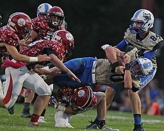 Ryan Slaven (30) of Western Reserve dives ahead for extra yardage as he is brought down by a group of Clipper defenders during Thursday night's matchup at Firestone Park in Columbiana. Dustin Livesay  |  The Vindicator  8/23/18  Columbiana