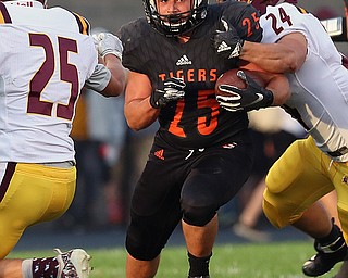 NEW MIDDLETOWN SPRINGFIELD, OHIO -August 24, 2018: SOUTH RANGE RAIDERS vs SPRINGFIIELD TIGERS at Tigers Stadium-   Middletown Springfield Tigers' Luke Snyder (25) breaks the attempted tackle of South Range Raiders' Anthony DeLucia (24) during the1st qtr.  MICHAEL G. TAYLOR | THE VINDICATOR