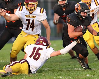 NEW MIDDLETOWN SPRINGFIELD, OHIO -August 24, 2018: SOUTH RANGE RAIDERS vs SPRINGFIIELD TIGERS at Tigers Stadium-   Middletown Springfield Tigers' Eric Dunkel (15) runs by South Range Raiders'Alec Ballentine (16) during the 1st qtr.  MICHAEL G. TAYLOR | THE VINDICATOR..