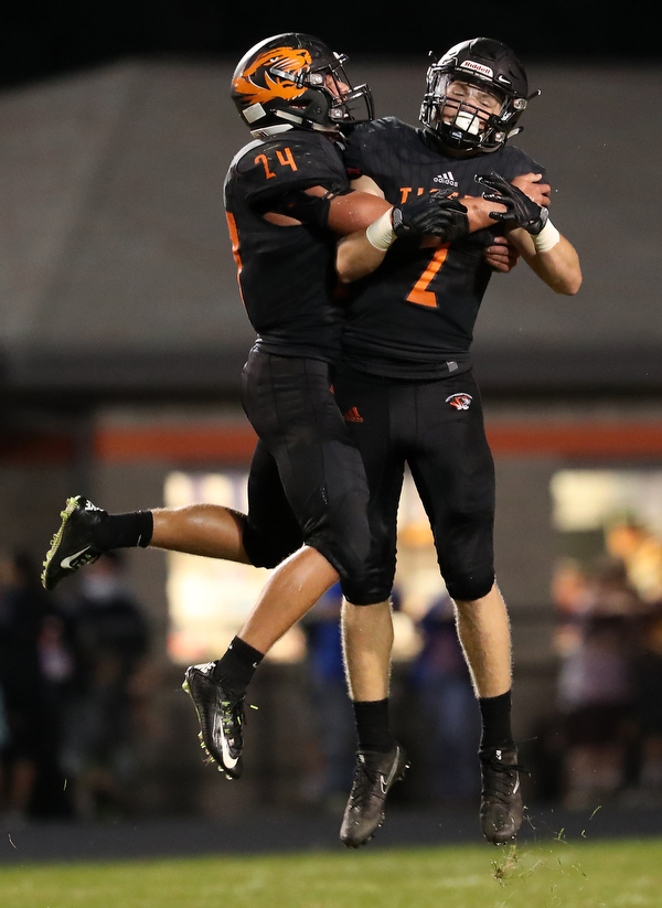 NEW MIDDLETOWN SPRINGFIELD, OHIO -August 24, 2018: SOUTH RANGE RAIDERS vs SPRINGFIIELD TIGERS at Tigers Stadium-  Springfield Tigers' Zachary Stouffer and Mitchell Seymour celebrate their victory.  MICHAEL G. TAYLOR | THE VINDICATOR