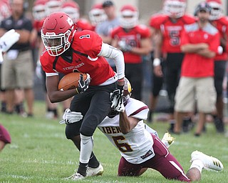 Keyshawn Chism (1) of Struthers gets wrapped up by Migel Burgess (6) of Liberty during Friday nights matchup against Liberty at Struthers High School. Dustin Livesay  |  The Vindicator  8/24/18  Struthers