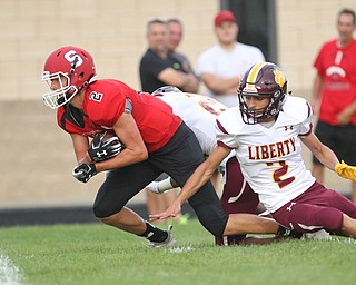 Carson Ryan (2) of Struthers tries to break away from a tackle by Liberty's Hamad Alhmeed (2) during Friday nights matchup at Struthers High School. Dustin Livesay  |  The Vindicator  8/24/18  Struthers