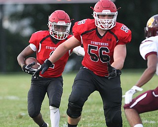 Keyshawn Chism (1) of Struthers runs behind his lead blocker Jake Vlosich (56) during Friday nights matchup against Liberty at Struthers High School. Dustin Livesay  |  The Vindicator  8/24/18  Struthers