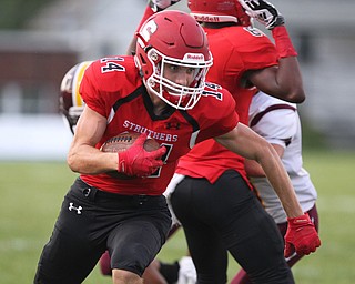 Aiden Hall (14) of Struthers cuts upfield after receiving a block by teammate Saun Peterson (8) on twon Liberty defenders during Friday nights matchup at Struthers High School. Dustin Livesay  |  The Vindicator  8/24/18  Struthers