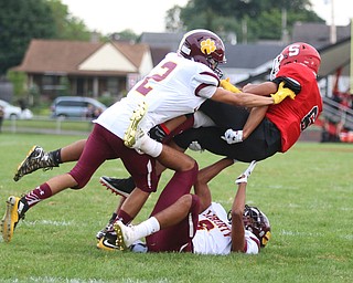 Adrian Brown (6) of Struthers gets brought down by a group of Liberty defenders during Friday nights matchup at Struthers High School. Dustin Livesay  |  The Vindicator  8/24/18  Struthers