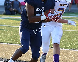 WAREEN, OHIO -August 25, 2018: CHAMPION FLASHES vs JOHN. F. KENNEDY EAGLES at Mollenkopf Stadium, Warren, OH-  JFK Eagles' Savone Williamson (3) catches a td as Champion Flashes' Noah Vesey (3) defends during the 1st qtr.  MICHAEL G. TAYLOR | THE VINDICATOR