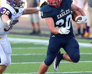 WAREEN, OHIO -August 25, 2018: CHAMPION FLASHES vs JOHN. F. KENNEDY EAGLES at Mollenkopf Stadium, Warren, OH-  JFK Eagles' Isaac Hadley (20) eludes the grasp of Champion Flashes' Austin Willforth (36)to gain a ist down during the 2nd qtr.  MICHAEL G. TAYLOR | THE VINDICATOR..