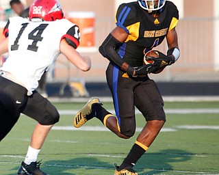 Valley Christian's Tyrone Lindsey runs the ball past Campbell's Jake Armeni during the first half of their game Saturday night at Dave Pavlansky Field in Poland. EMILY MATTHEWS | THE VINDICATOR