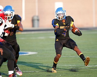 Valley Christian's Tyrone Lindsey runs with the ball during the first half of their game Saturday night at Dave Pavlansky Field in Poland. EMILY MATTHEWS | THE VINDICATOR