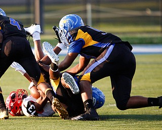 Campbell's Daquan Bebbs is tackled by Valley Christian during the first half of their game Saturday night at Dave Pavlansky Field in Poland. EMILY MATTHEWS | THE VINDICATOR