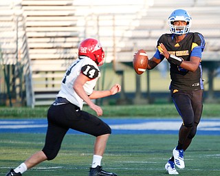 Valley Christian's Milan Square prepares to throw the ball as Campbell's Jake Armeni advances toward him during the first half of their game Saturday night at Dave Pavlansky Field in Poland. EMILY MATTHEWS | THE VINDICATOR