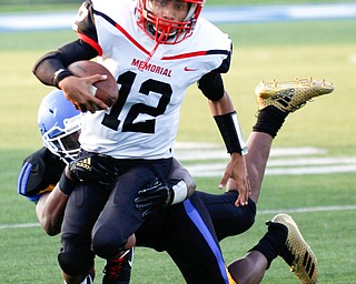 Campbell's Christian Stores gets tackled by Valley Christian's Altwjuan Beck-Lindsey during the first half of their game Saturday night at Dave Pavlansky Field in Poland. EMILY MATTHEWS | THE VINDICATOR