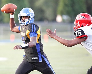 Valley Christian's Milan Square prepares to throw the ball as Campbell's Jashon Flores advances toward him during the first half of their game Saturday night at Dave Pavlansky Field in Poland. EMILY MATTHEWS | THE VINDICATOR