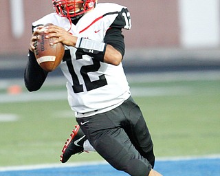 Campbell's Christian Stores runs with the ball before throwing it during the first half of the game against Valley Christian Saturday night at Dave Pavlansky Field in Poland. EMILY MATTHEWS | THE VINDICATOR