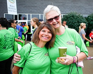 Friends and co-workers at Home Savings Janet Guerrieri, left, and Pat Barber, a breast cancer survivor, pose for a photo before the start of Panerathon outside of Covelli Centre on Sunday. .EMILY MATTHEWS | THE VINDICATOR