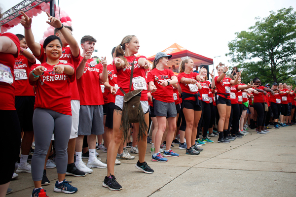 Students on the YSU nurses race team conduct a flash mob before the start of Panerathon outside of Covelli Centre on Sunday. .EMILY MATTHEWS | THE VINDICATOR
