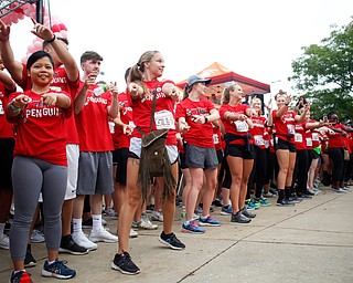 Students on the YSU nurses race team conduct a flash mob before the start of Panerathon outside of Covelli Centre on Sunday. .EMILY MATTHEWS | THE VINDICATOR