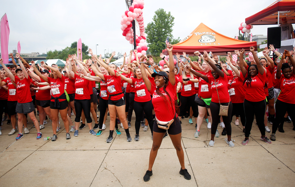 Shauntiaonia Johnson, center, a senior studying nursing at YSU, conducts a flash mob with other nursing students before the start of Panerathon outside of Covelli Centre on Sunday. .EMILY MATTHEWS | THE VINDICATOR