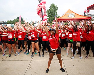 Shauntiaonia Johnson, center, a senior studying nursing at YSU, conducts a flash mob with other nursing students before the start of Panerathon outside of Covelli Centre on Sunday. .EMILY MATTHEWS | THE VINDICATOR