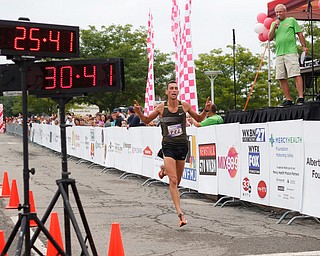 Aiman Scullion, of Akron who grew up in Salem, gets ready to be the first 10k runner to cross the finish line at Panerathon outside of Covelli Centre on Sunday. .EMILY MATTHEWS | THE VINDICATOR