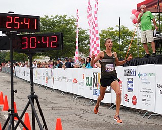 Aiman Scullion, of Akron who grew up in Salem, gets ready to be the first 10k runner to cross the finish line at Panerathon outside of Covelli Centre on Sunday. .EMILY MATTHEWS | THE VINDICATOR