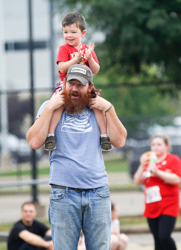 Danny Young, of Kinsman, and his son Orry Young cheer on 10k runners on Walnut Street during Panerathon on Sunday. .EMILY MATTHEWS | THE VINDICATOR