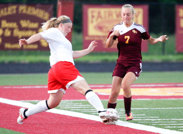 Niles McKinley's Mackenzie Johnston kicks the ball past South Range's Addie Flowers during their game Monday night at South Range.