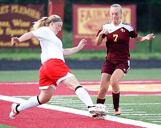 Niles McKinley's Mackenzie Johnston kicks the ball past South Range's Addie Flowers during their game Monday night at South Range.