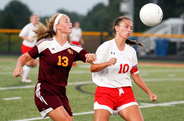 Niles McKinley's Jaycee Ward, right, and South Range's Bree Kohler go after the ball during their game Monday night at South Range.