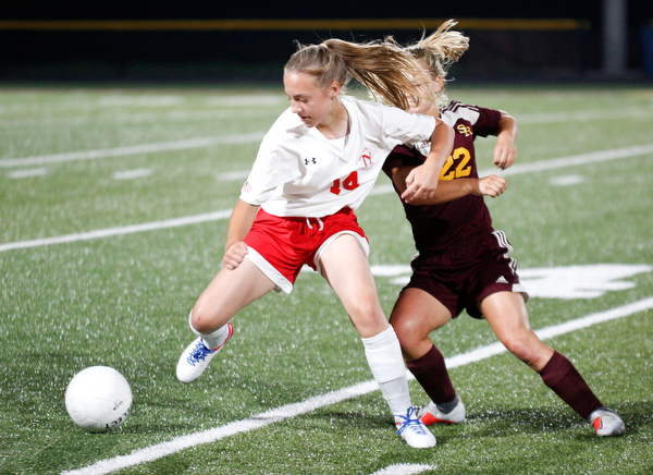 Niles McKinley's Allison Cline tries to keep the ball away from South Range's Alyssa Tracy during their game Monday night at South Range.