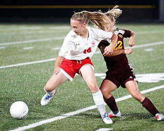 Niles McKinley's Allison Cline tries to keep the ball away from South Range's Alyssa Tracy during their game Monday night at South Range.