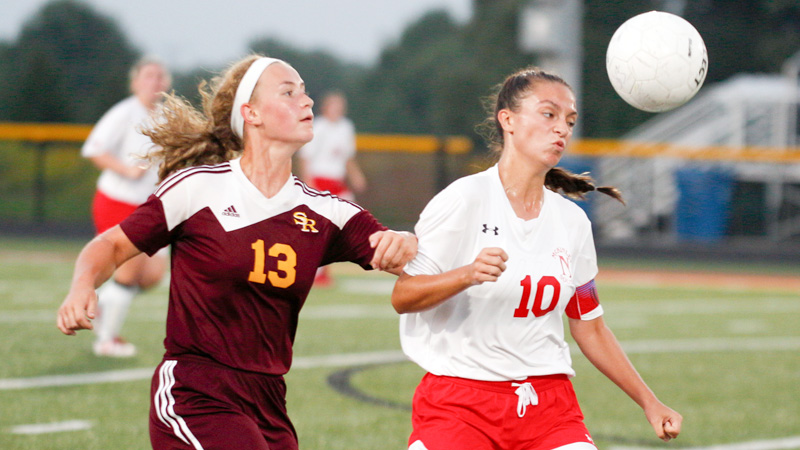 Niles’ Jaycee Ward, right, and South Range’s Bree Kohler go after the ball during Monday’s game in Beaver Township. Ward scored the game-winner in a 4-3 victory.