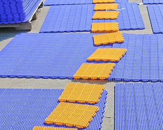  ROBERT K.YOSAY  | THE VINDICATOR..laying out the yellow lines- Kathy Davis.... puts together a yellow line for the field..Mill Creek ParkÕs old ice skating rink is getting a blue makeover courtesy of a team that wears black and gold..On Tuesday morning, volunteers from Mill Creek MetroParks, Home Savings and Loan, the Youngstown Phantoms and The Pittsburgh Penguins Foundation were laying down blue tiles for the ParkÕs new dek hockey rink