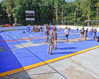  ROBERT K.YOSAY  | THE VINDICATOR..Mill Creek ParkÕs old ice skating rink is getting a blue makeover courtesy of a team that wears black and gold..On Tuesday morning, volunteers from Mill Creek MetroParks, Home Savings and Loan, the Youngstown Phantoms and The Pittsburgh Penguins Foundation were laying down blue tiles for the ParkÕs new dek hockey rinkNiles McKinley's Isabella Sergi tries to keep the ball away from South Range's Kiley McConnell during their game Monday night at South Range.