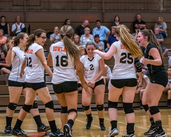 DIANNA OATRIDGE | THE VINDICATOR The Howland volleyball team celebrates after scoring a point during their match against Boardman in Howland on Tuesday. The Spartans won the match 3-0.